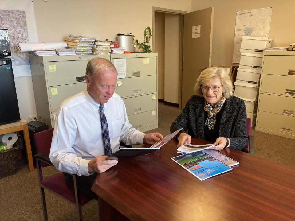 Mayor Paul Coogan and RDA Executive Director Sarah Page look over proposals from three design firms to help create a master plan for Route 79 redevelopment.