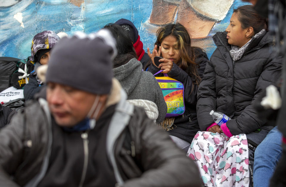 A migrant from Venezuela applies makeup while camping outside the Sacred Heart Church in El Paso, Texas, on Sunday, Dec. 18, 2022. (AP Photo/Andres Leighton)