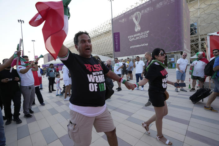 Protesters wear t-shirts reading "Rise with the women of Iran" outside the Ahmad Bin Ali Stadium at the end of the World Cup group B soccer match between Wales and Iran, in Al Rayyan, Qatar, Friday, Nov. 25, 2022. (AP Photo/Alessandra Tarantino)