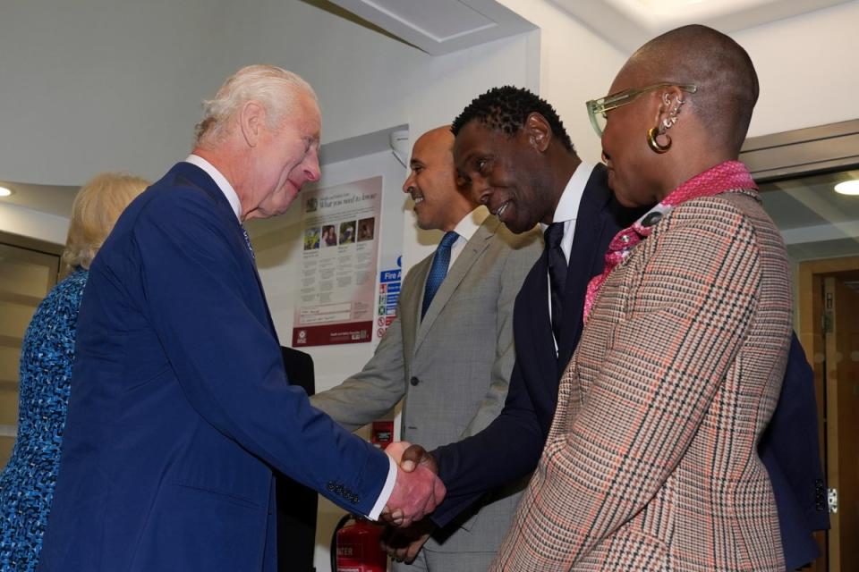 Charles and Camilla meet oresident of RADA, David Harewood and actress, singer and Vice President, Cynthia Erivo (AP)