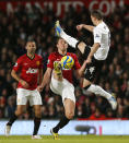 Manchester United's Michael Carrick (C) is challenged by Fulham's Chris Baird (R) during their FA Cup fourth round soccer match at Old Trafford in Manchester, northern England, January 26, 2013. REUTERS/Phil Noble (BRITAIN - Tags: SPORT SOCCER TPX IMAGES OF THE DAY) - RTR3D00L