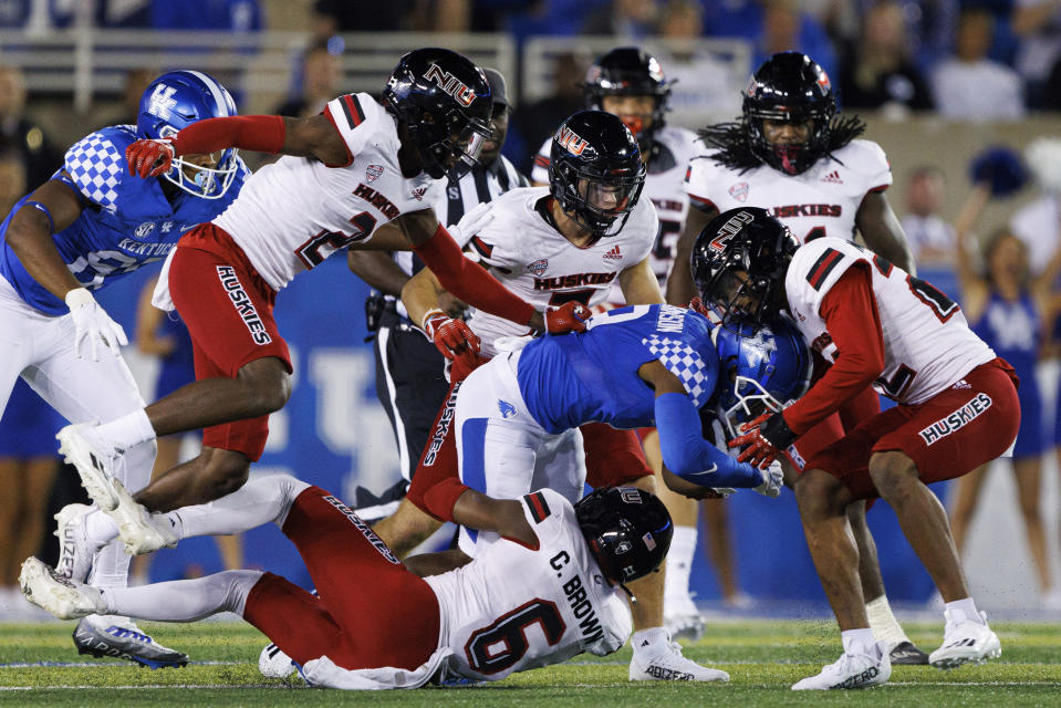 Kentucky wide receiver Tayvion Robinson (9) is brought down by Northern Illinois safety CJ Brown (6) during the second half of an NCAA college football game in Lexington, Ky., Saturday, Sept. 24, 2022. (AP Photo/Michael Clubb)