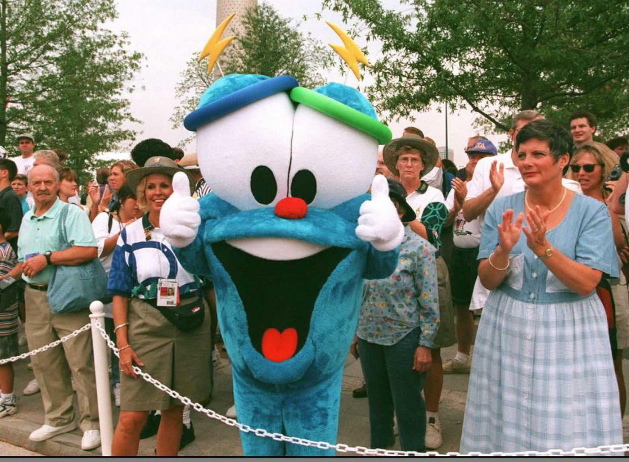 ATLANTA, GA - JULY 13:  Izzy, the Mascot of the Centennial Olympics, walks by spectators during the opening ceremony of the Centennial Olympic park 13 July in Atlanta. The 26th Summer Olympic Games are scheduled to open 19 July in Atlanta. AFP PHOTO  (Photo credit should read MICHEL GANGNE/AFP via Getty Images)