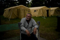 Mykola Kovalenko, who lost his home during the Russian invasion, rests outside at a Sanatorium working as temporary place for people without a home Irpin, outskirts Kyiv, Ukraine, Thursday, May 26, 2022. (AP Photo/Natacha Pisarenko)