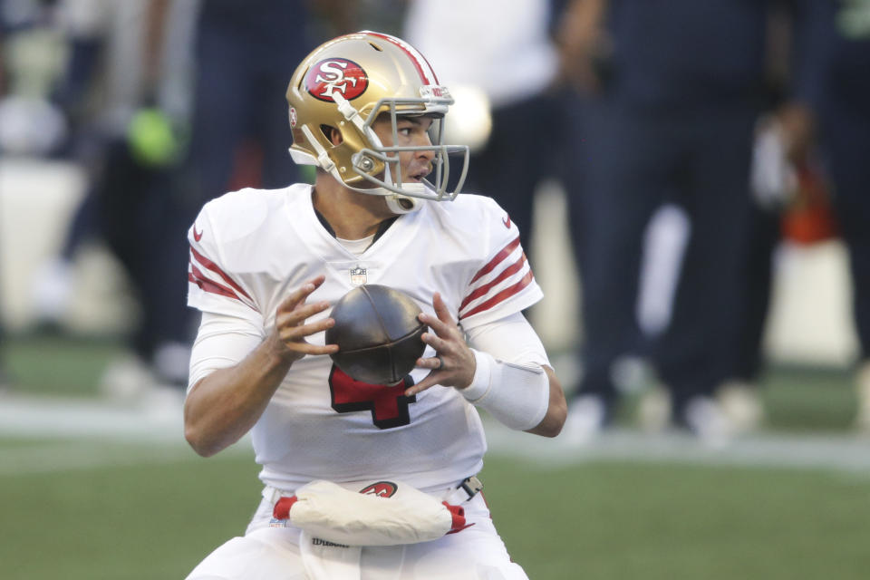 San Francisco 49ers quarterback Nick Mullens drops to pass during the second half of an NFL football game against the Seattle Seahawks, Sunday, Nov. 1, 2020, in Seattle. (AP Photo/Scott Eklund)