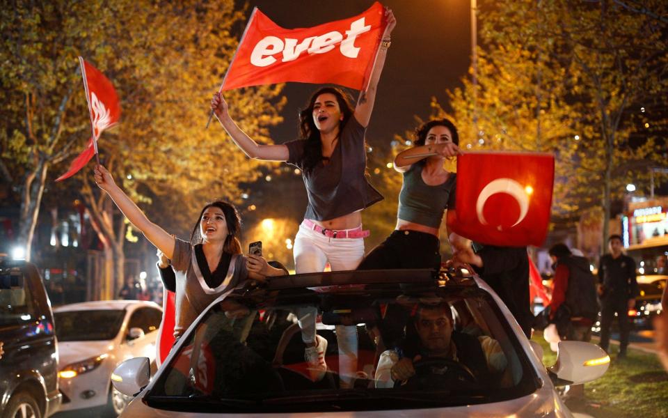 Yes supporters celebrate after narrowly winning Sunday's referendum - AP