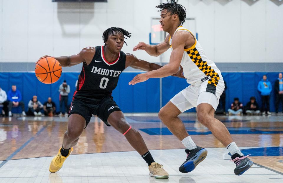 Imhotep Charter's Ahmad Nowell (0) tries to create space against Archbishop Wood's Josh Reed (5) in the Diane Mosco Shootout in Bensalem on Friday, Dec. 22, 2023.

Daniella Heminghaus | Bucks County Courier Times