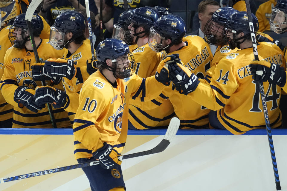 Quinnipiac forward Ethan de Jong (10) celebrates with the bench after his goal against Michigan during the third period of an NCAA semifinal game in the Frozen Four college hockey tournament Thursday, April 6, 2023, in Tampa, Fla. (AP Photo/Chris O'Meara)