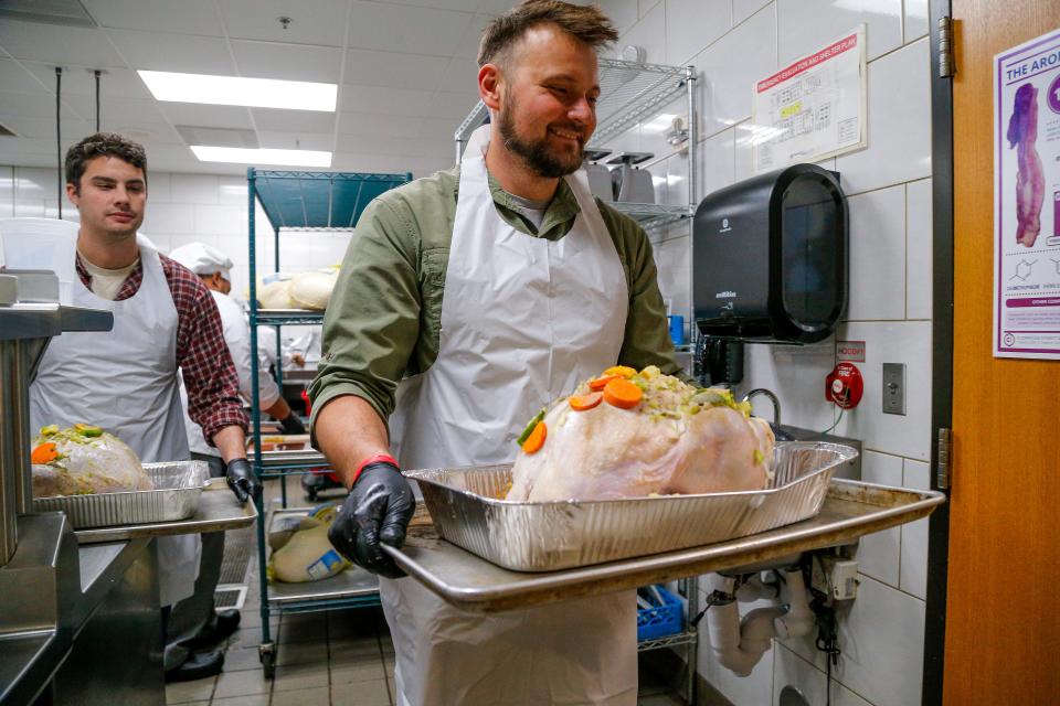 Shane Allen finishes stuffing a turkey Monday for the annual Turkey Tango to feed Homeless Alliance at Francis Tuttle Culinary Arts in Oklahoma City.