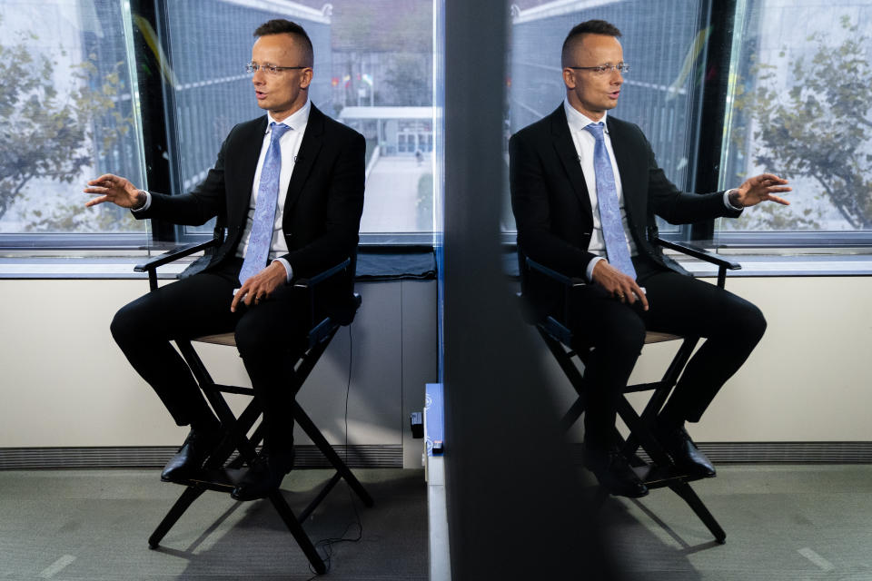 Peter Szijjarto, Hungary's minister of foreign affairs and trade, is reflected in studio glass as he speaks during an interview with the Associated Press at United Nations headquarters, Thursday, Sept. 23, 2021, during the 76th Session of the U.N. General Assembly in New York. (AP Photo/John Minchillo)