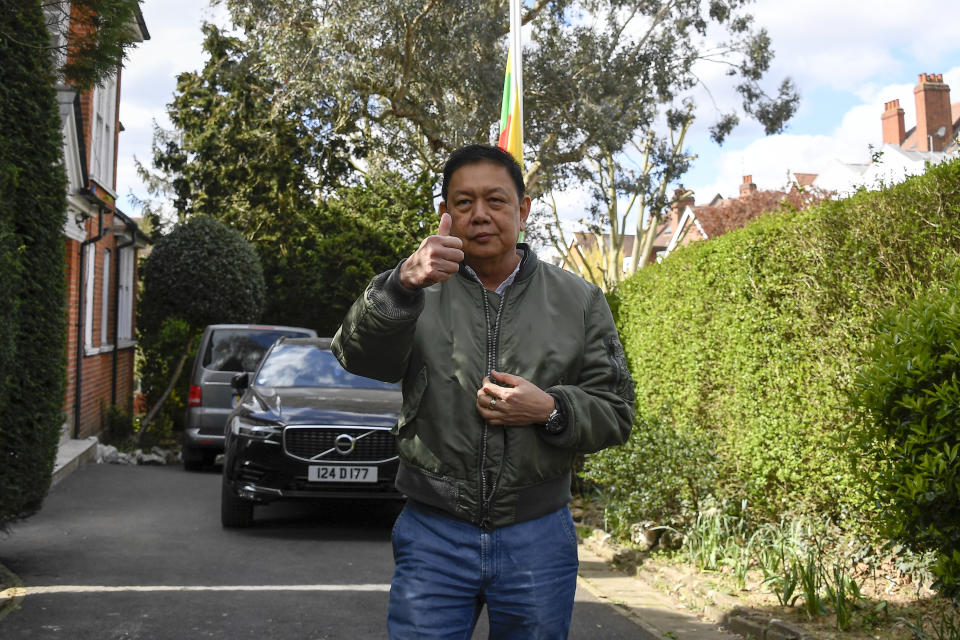 Myanmar’s ambassador to the United Kingdom, Kyaw Zwar Minn, gestures to the media outside his residence in London, Thursday, April 15, 2021. The Myanmar ambassador who has criticized the military coup in his country is due to be evicted from the property after the embassy was taken over by diplomats loyal to the military regime last Wednesday. (AP Photo/Alberto Pezzali)