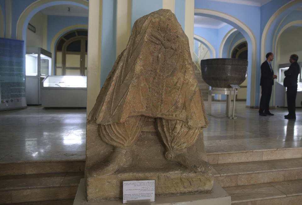 In this Saturday, Aug. 17, 2019 photo, a statue which was destroyed by Taliban fighters is on display after it was restored, at the National Museum of Afghanistan in Kabul, Afghanistan. The Taliban fighters arrived with hammers and hatred. Fragments of what they left behind have been laid out on tables at the National Museum of Afghanistan, 18 years later: shattered pieces of ancient Buddha figurines smashed because they were judged to be against Islam. (AP Photo/Rafiq Maqbool)