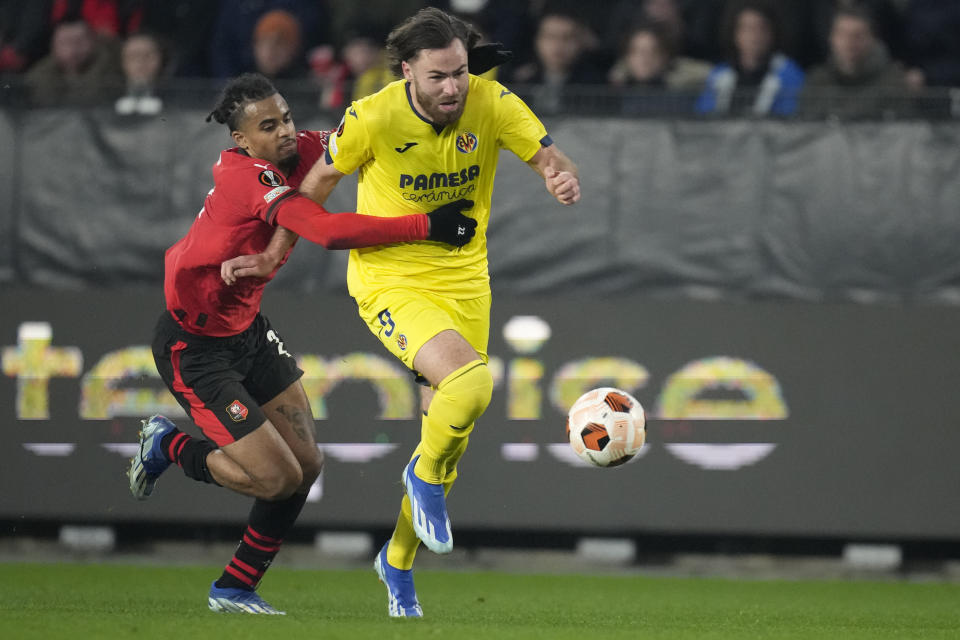 Rennes' Lorenz Assignon, left, challenges with Villarreal's Ben Brereton Diaz during the Europa League Group F soccer match between Rennes and Villarreal at the Roazhon Park stadium in Rennes, western France, Thursday, Dec. 14, 2023. (AP Photo/Christophe Ena)