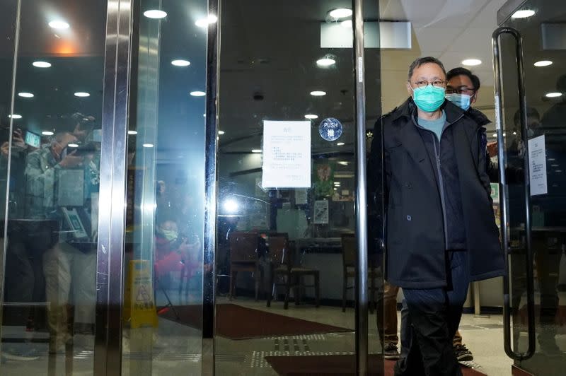 Pro-democracy activist Benny Tai leaves the police station on bail in Hong Kong