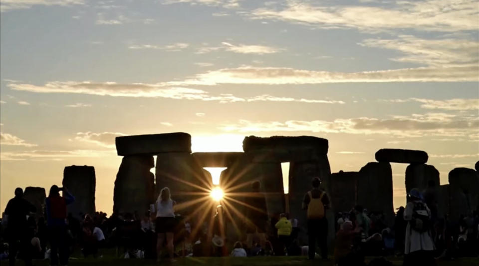 The sun sets over Stonehenge as a crowd gathers to celebrate the summer solstice in the British county of Wiltshire on Thursday, June 20, 2024. / Credit: English Heritage via Reuters