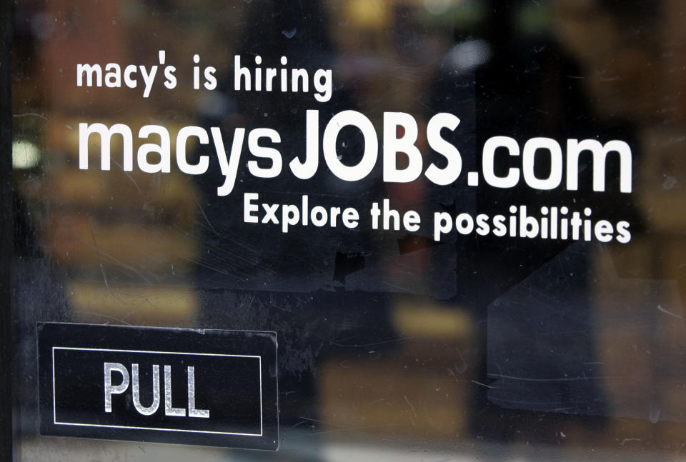 FILE - In this Monday, Feb. 2, 2009, file photo, a hiring sign is displayed on the front door of a Macy's store in Palo Alto, Calif. Macy's announced Wednesday, Jan. 8, 2014, that it is laying off 2,500 workers as it restructures business. (AP Photo/Paul Sakuma, File)