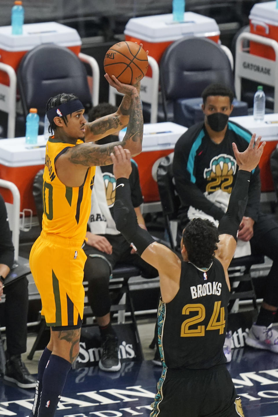 Utah Jazz guard Jordan Clarkson (00) shoots as Memphis Grizzlies forward Dillon Brooks (24) defends in the first half during an NBA basketball game Saturday, March 27, 2021, in Salt Lake City. (AP Photo/Rick Bowmer)