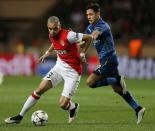 Monaco's Layvin Kurzawa (L) challenges Arsenal's Alexis Sanchez during their Champions League round of 16 second leg soccer match at the Louis II Stadium in Monaco, March 17, 2015. REUTERS/Jean-Paul Pelissier (MONACO - Tags: SPORT SOCCER)