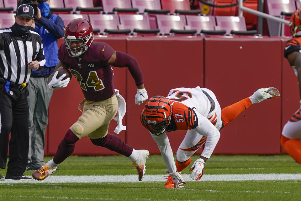 Washington Football Team running back Antonio Gibson (24) runs past Cincinnati Bengals linebacker Germaine Pratt (57) during the first half of an NFL football game, Sunday, Nov. 22, 2020, in Landover. (AP Photo/Susan Walsh)