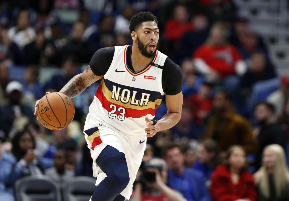 FILE - In this March 16, 2019, file photo, New Orleans Pelicans forward Anthony Davis brings the ball up during the first half of the team's NBA basketball game against the Phoenix Suns in New Orleans. Two people familiar with the situation say the Pelicans have agreed to trade Davis to the Los Angeles Lakers for point guard Lonzo Ball, forward Brandon Ingram, shooting guard Josh Hart and three first-round draft choices. The people spoke to The Associated Press on condition of anonymity because the trade cannot become official until the new league year begins July 6. ESPN first reported the trade.(AP Photo/Tyler Kaufman, File)