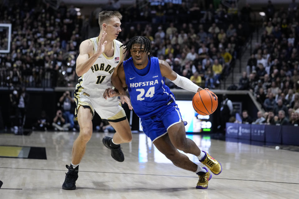 Hofstra guard Amar'e Marshall (24) drives on Purdue forward Brian Waddell (11) during the first half of an NCAA college basketball game in West Lafayette, Ind., Wednesday, Dec. 7, 2022. (AP Photo/Michael Conroy)