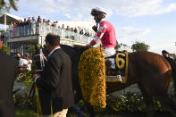 Flavien Prat atop Rombauer heads to the winner's circle after winning the Preakness Stakes horse race at Pimlico Race Course, Saturday, May 15, 2021, in Baltimore. (AP Photo/Will Newton)