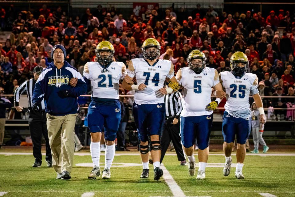 Lloyd Memorial coach Kyle Niederman and captains Amari Riley (21), Joe Cooley (74), Avander Abrams (5) and Kaiden Zulager (25) approach for the coin toss in the KHSAA Class 2A state semifinal between Lloyd Memorial and Beechwood high schools Friday, Nov. 25, 2022.