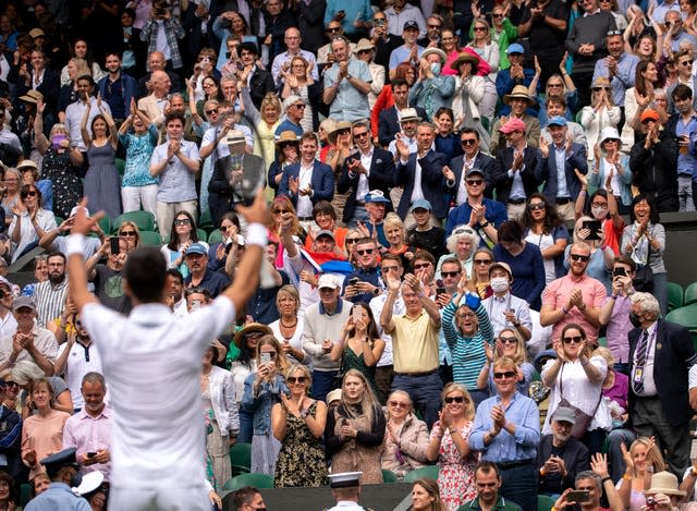 Novak Djokovic signals to the crowd after his victory