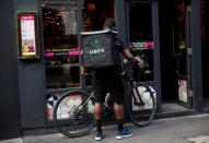 An UberEATS food delivery courier prepares his bike in London, Britain September 7, 2016. REUTERS/Neil Hall