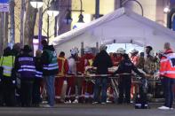 <p>Rescue workers gather outside a tent as victims of the truck attack are treated. Photo: Sean Gallup/Getty Images</p>