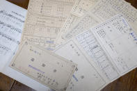 Report cards of Fumie Sato's first to sixth grades from the elementary school in Manchuria, China, are seen Friday, Aug. 7, 2020, at her home in Yokohama, Japan. Hours after Sato heard Emperor Hirohito's Aug. 15 radio speech declaring Japan's defeat at her school ground in Manchuria, China, she had to be prepared for honorable suicide with her family, though her father decided his family must live. Two years later she almost became an orphan when her little sister died of illness after their mother and little brother took an earlier boat back to Japan. (AP Photo/Kiichiro Sato)