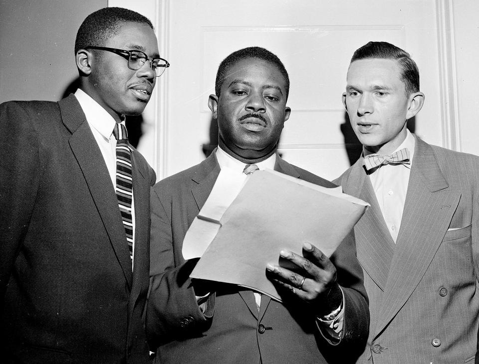 Rev. Ralph D. Abernathy, center, speaks with attorney Fred D. Gray, left, and the Rev. Robert S. Graetz, right of Abernathy, about the bus boycott settlement in Montgomery, Ala., on Feb. 21, 1956.  (AP Photo)