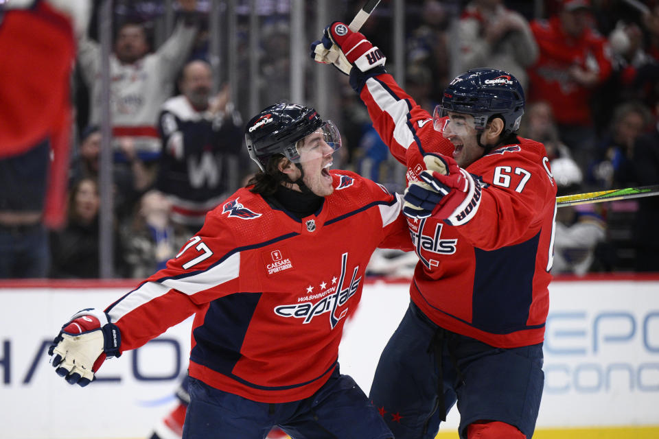 Washington Capitals right wing T.J. Oshie (77) celebrates his goal against the St. Louis Blues with left wing Max Pacioretty (67) during the first period of an NHL hockey game Thursday, Jan. 18, 2024, in Washington. (AP Photo/Nick Wass)