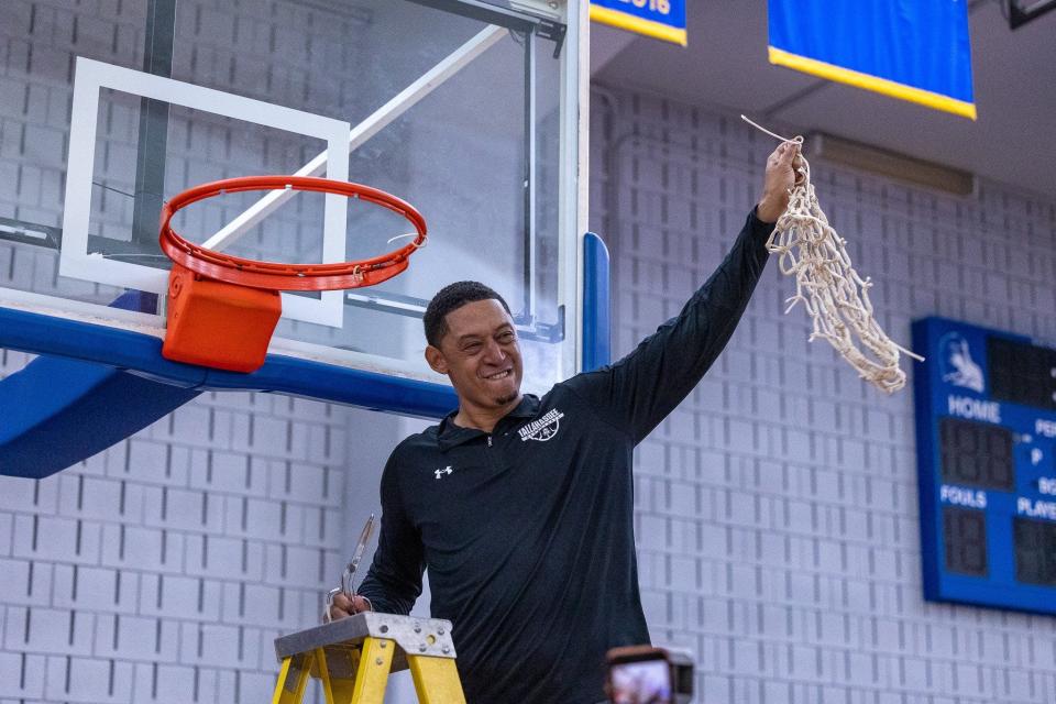 Tallahassee Community College men's basketball head coach Rick Cabrera celebrates cutting the net after winning one-third of the Panhandle Conference Championship against Chipola College at the Bill Hebrock Eagledome in Tallahassee, Florida on Saturday, Feb. 25, 2023