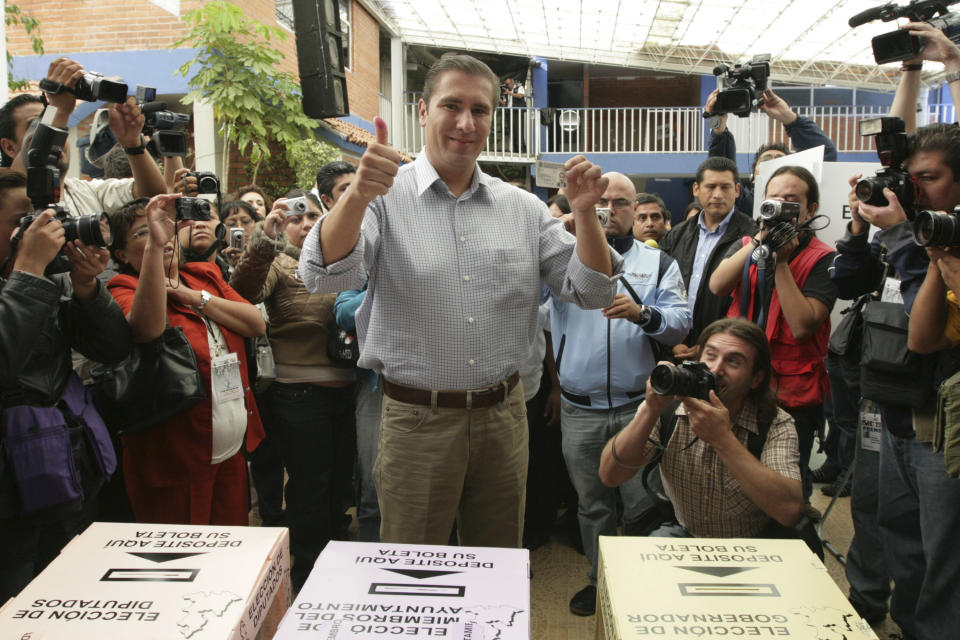FILE - In this July 4, 2010 file photo, Rafael Moreno Valle, candidate of the "Compromiso por Puebla" party coalition, flashes two thumbs up after casting his vote during state elections in Puebla, Mexico. Moreno Valle, who went on to win the 2010 gubernatorial race, died in what local media are reporting as a helicopter crash on Christmas Eve, Monday, Dec. 24, 2018, along with his wife Martha Erika Alonso, who is currently the governor of Puebla. (AP Photo/Joel Merino, File)