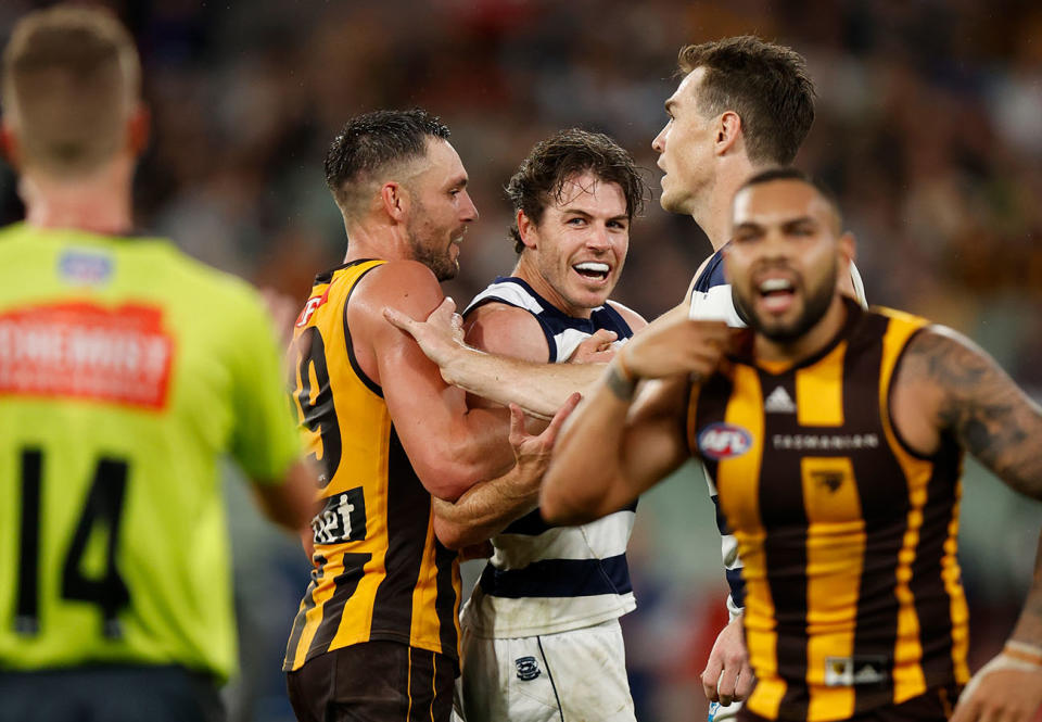 Isaac Smith, pictured here tangling with Jack Gunston in Geelong's clash with Hawthorn.