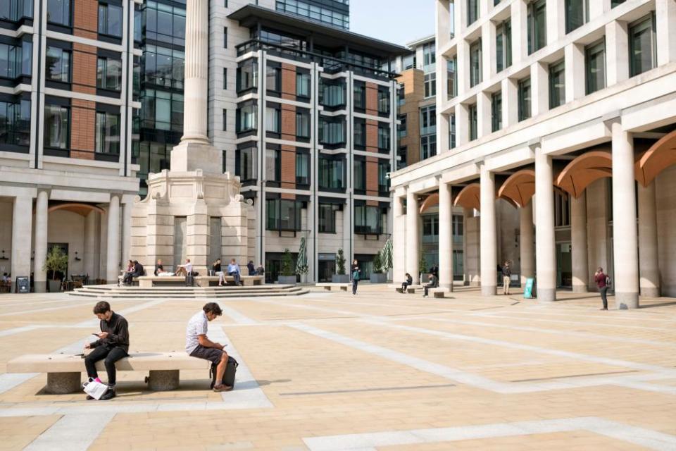 Workers in the formerly bustling Paternoster Square at lunchtime.