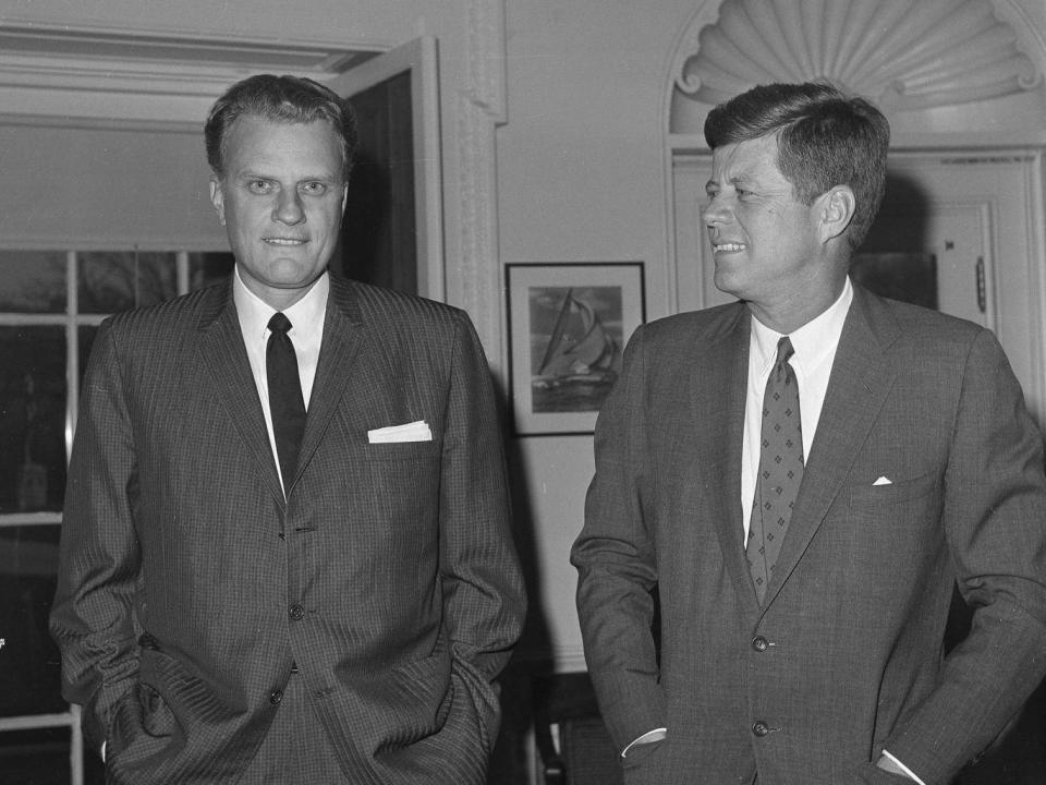 Graham, who became a counsellor to several US presidents, with John F Kennedy at the White House (AP)