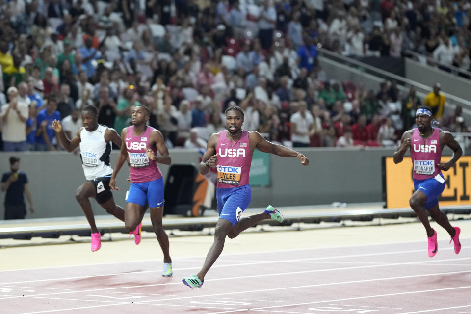 Noah Lyles, of the United States, center, crosses the finish line to win the gold medal in the Men's 200-meters final (AP Photo/Bernat Armangue)