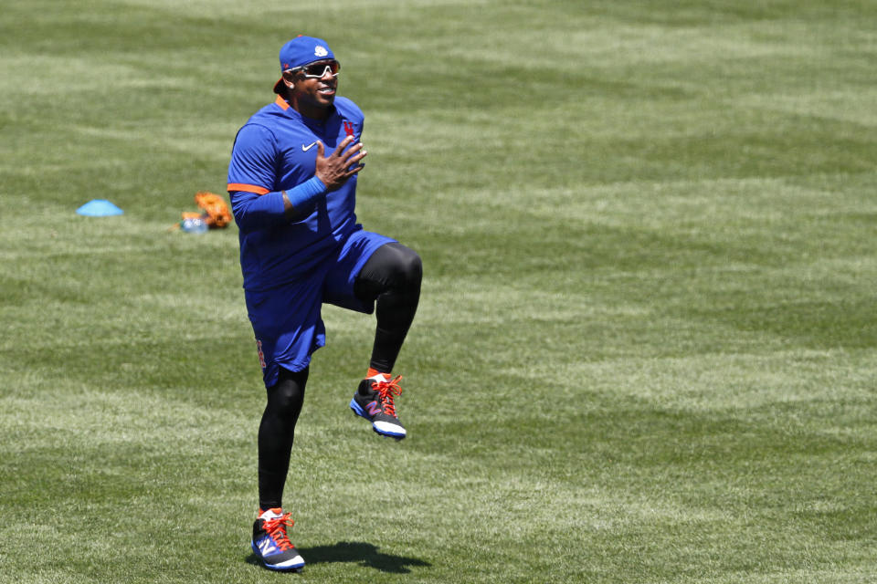 New York Mets left fielder Yoenis Cespedes warms up during the afternoon session of a summer baseball training camp workout at Citi Field, Thursday, July 9, 2020, in New York. (AP Photo/Kathy Willens)