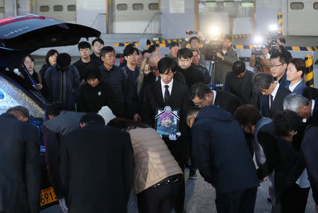 Family members and relatives bow to a coffin carrying a body of one of the five South Korean climbers who were killed in the Himalayas, at Incheon International Airport in Incheon, South Korea, October 17, 2018. Yonhap via REUTERS