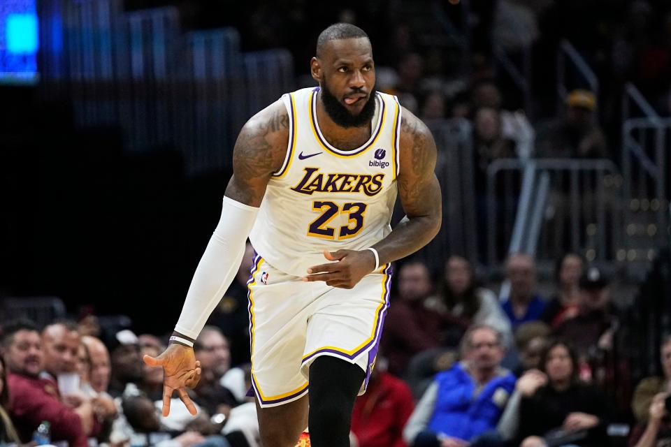 Lakers forward LeBron James gestures after hitting a second-half 3-point shot against the Cavaliers, Saturday, Nov. 25, 2023, in Cleveland.