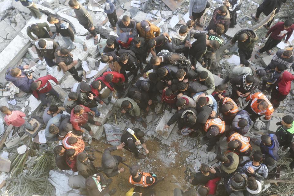 People searching for survivors in a destroyed mosque in Rafah, Gaza