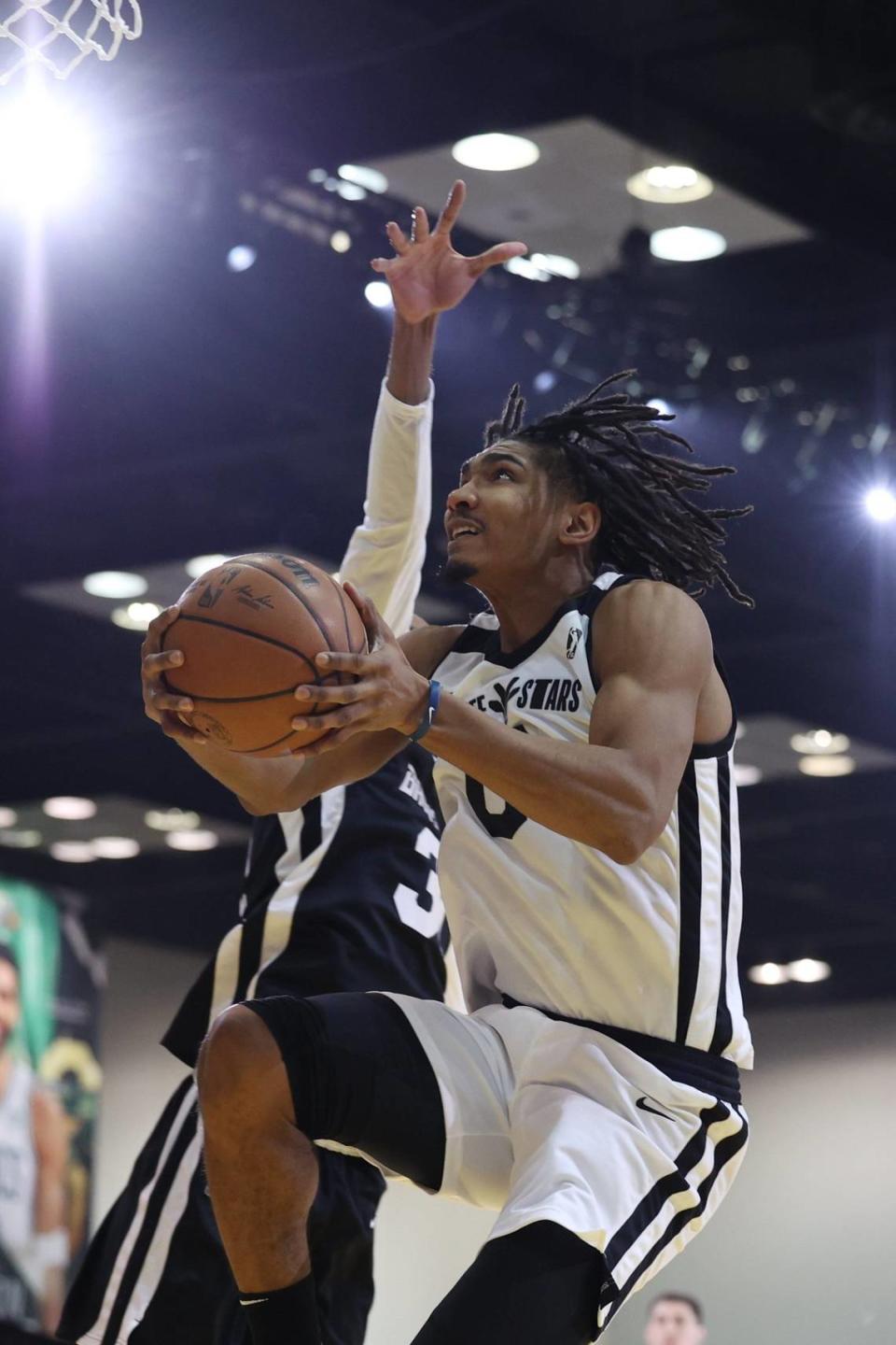 Feb 18, 2024; Indianapolis, Indiana, USA; Team Giraffe Stars forward Ron Holland (0) of the G League Ignite leaps for the net against Team BallIsLife during the G-League Next Up game at Indiana Convention Center. Mandatory Credit: Trevor Ruszkowski-USA TODAY Sports