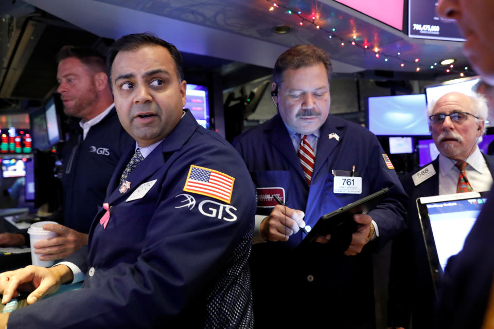 Traders work on the floor at the New York Stock Exchange (NYSE) in New York, U.S., December 9, 2019. REUTERS/Brendan McDermid