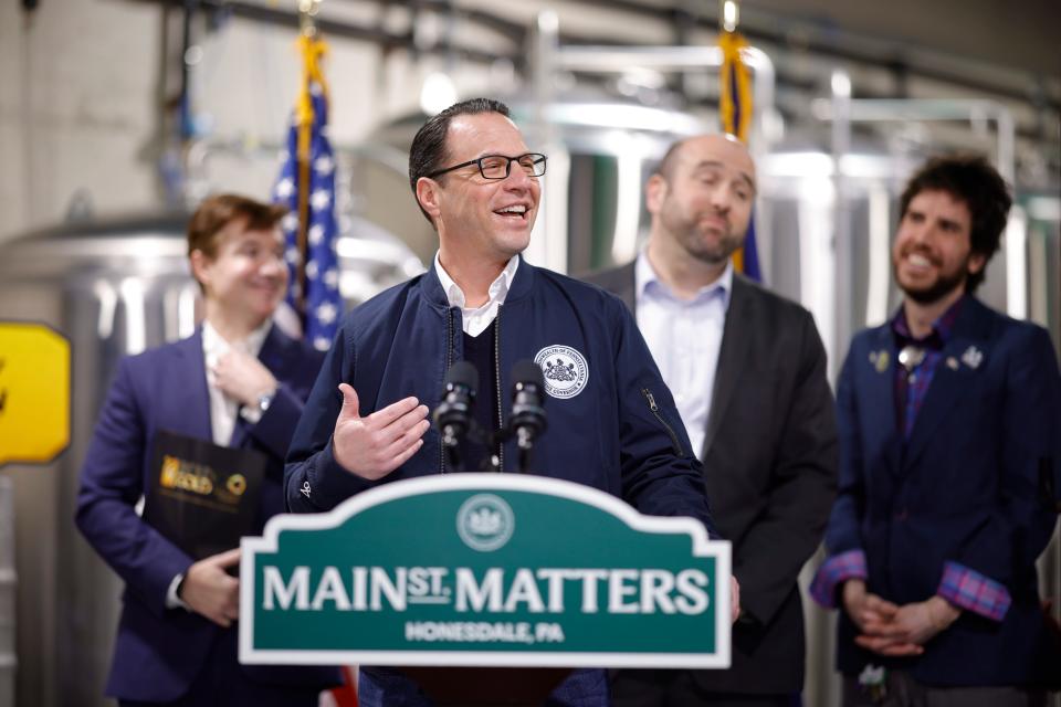 Gov. Josh Shapiro speaks at the press conference held at Runaway Train Brewery in Honesdale on Feb. 16, 2024. In back, from left are Vince Benedetto, owner of Runaway Train; DCED Secretary Rick Sigar; and Honesdale Mayor Derek Williams.