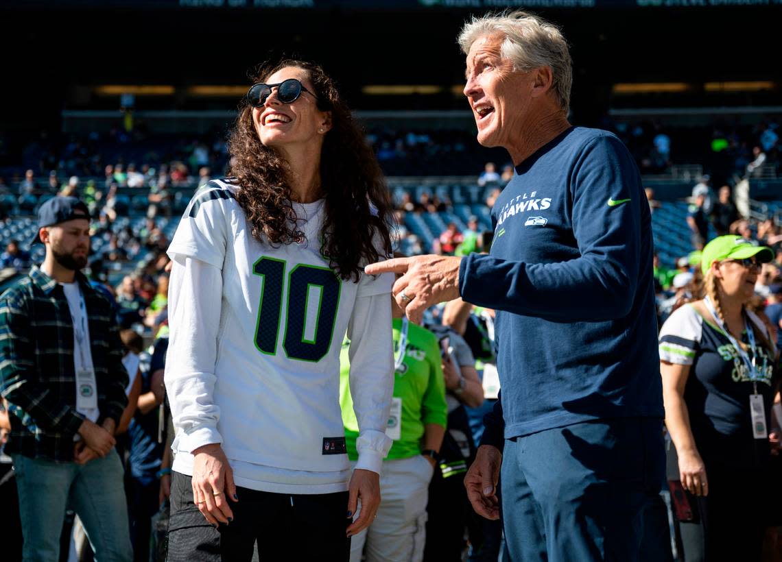 Seattle Seahawks head coach Pete Carroll talks with recently retired WNBA Seattle Storm point guard Sue Bird on the sidelines before the start of an NFL game at Lumen Field in Seattle, Wash. on Sept. 25, 2022.