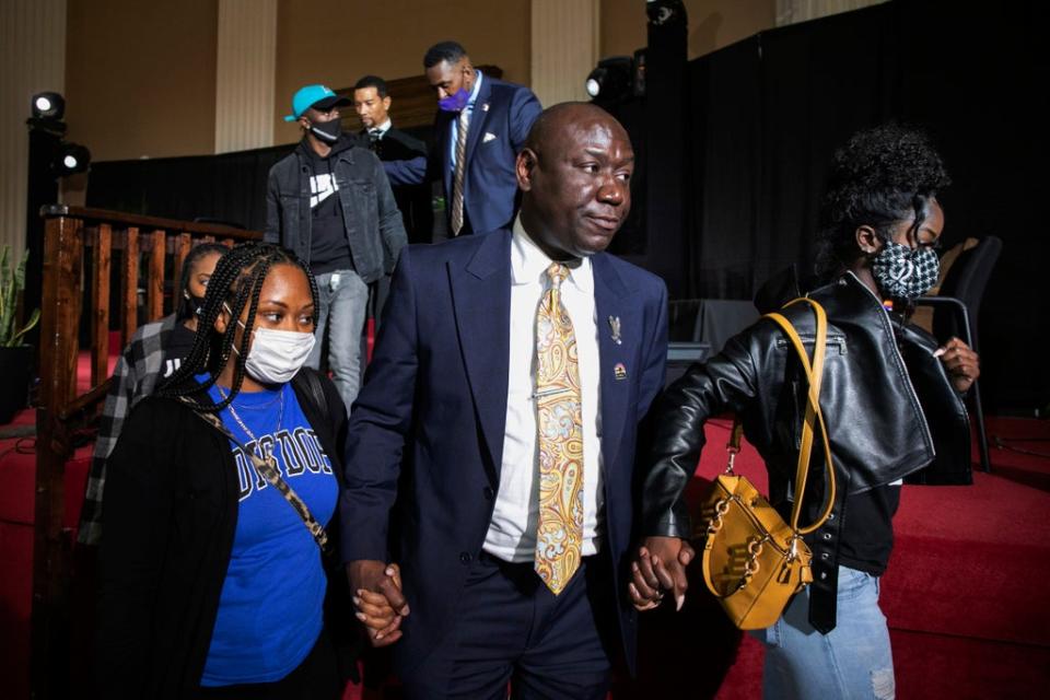 Attorney Ben Crump walks with Jelani Day's sisters Dacara Bolden (left) and Zena Day (right) at Friday’s press conference as his family call for the FBI to take the case (AP)