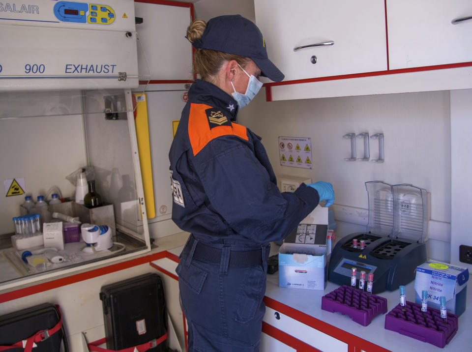 In this picture taken on Thursday, May 21, 2020, Italian Coast Guard's biologists show how they perform tests on sea water in a mobile lab during an interview with The Associated Press in Fiumicino, near Rome. Preliminary results from a survey of seawater quality during Italy’s coronavirus lockdown indicate a sharp reduction in pollution from human and livestock waste in the seas off Rome. Authorities stressed it was too soon to give the lockdown sole credit for the change. (AP Photo/Domenico Stinellis)