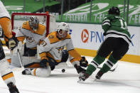 Nashville Predators goaltender Pekka Rinne (35) and defenseman Dante Fabbro (57) defend against a shot by Dallas Stars center Ty Dellandrea (10) in the second period during an NHL hockey game on Sunday, March 7, 2021, in Dallas. (AP Photo/Richard W. Rodriguez)